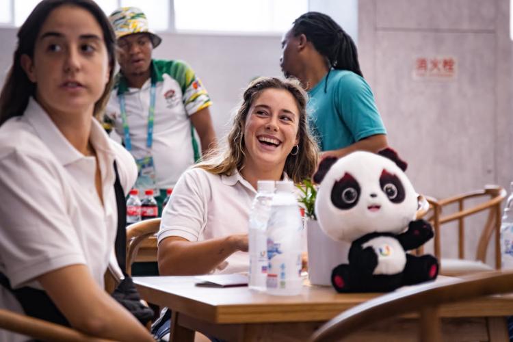 Carolina Rodrigues, captain of Portugal's women's basketball team at #Chengdu #Universiade, noted the delightful time despite the spicy cuisine. The well-equipped rooms, clean training spaces, reliable internet, and organized schedules left a lasting impact on her. #FISUGames