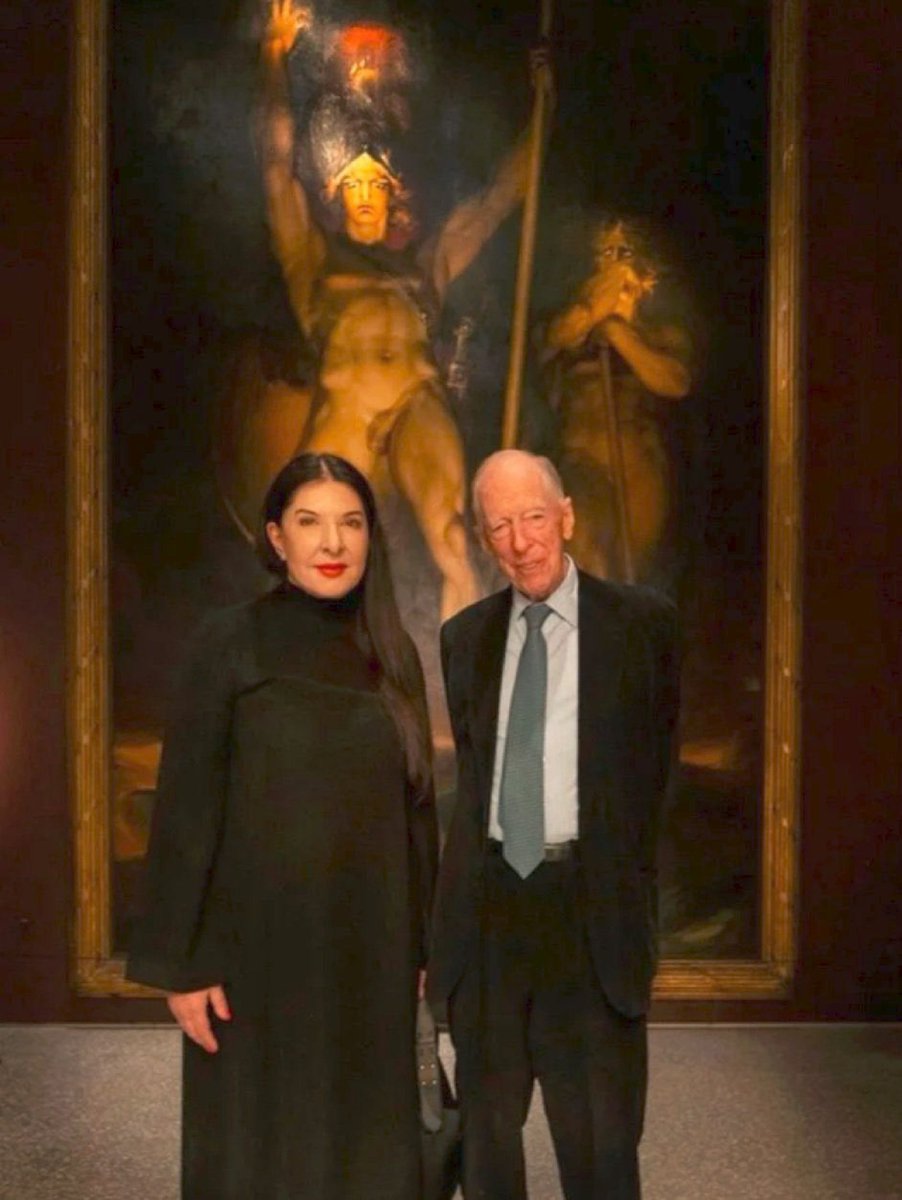 WallStreetApes's tweet photo. Self Proclaimed Satanic Witch &amp; Spirit Cooker Marina Abramović Posing Next To Global Ruler Jacob Rothschild In Front Of The Painting "Satan Summoning His Legions”

If you question this is anything more than just two people posing for a photo you are labeled a conspiracy theorist. https://t.co/xmebsqwdH7