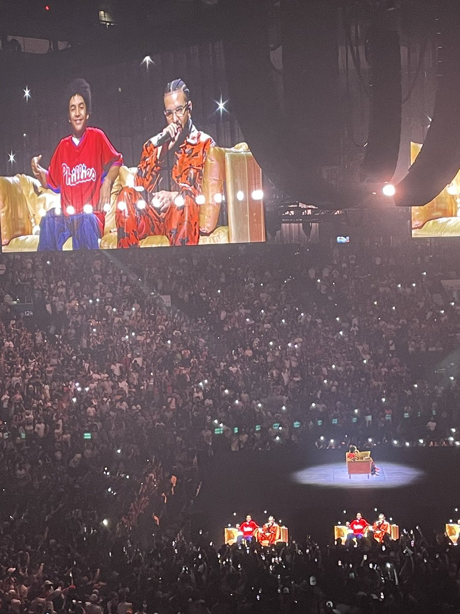 JClarkNBCS's tweet image. Drake starts his concert at the Wells Fargo Center tonight with a hologram of his younger self wearing a Phillies shirt