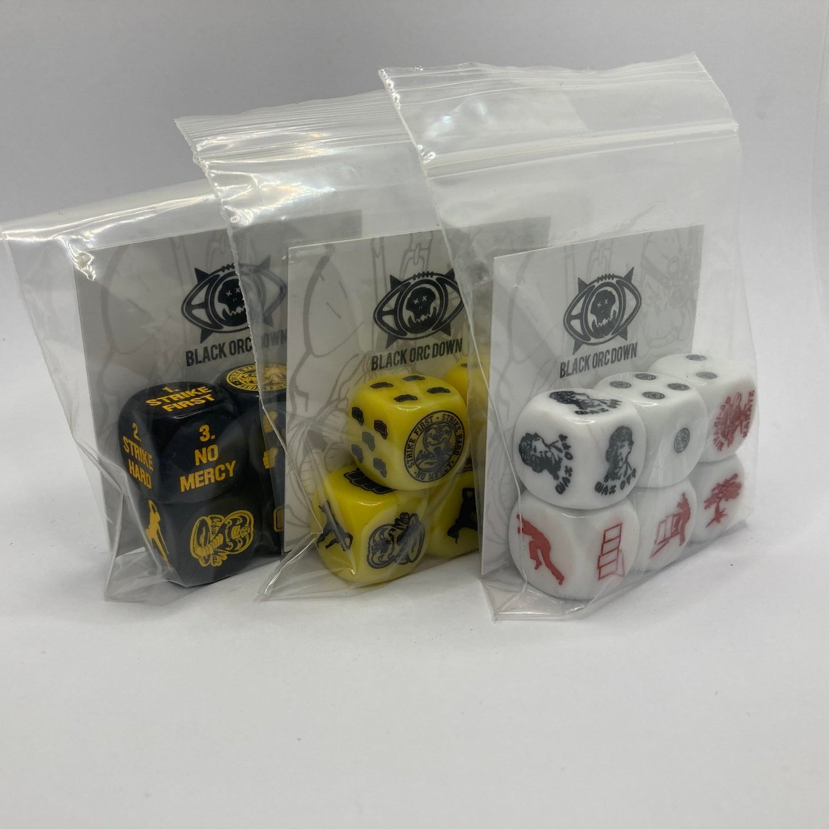 The #Flingnation metal Cherry Pie ball token (#28) 
Now comes with a set of Cherry pie red Flingnation dice. 
And a One of a kind set of Purple Thrudnation dice. 

The Cobra Kai sets (#57) Are 3 sets not 2. They are the last sets Black Orc Down have. Never to be remade