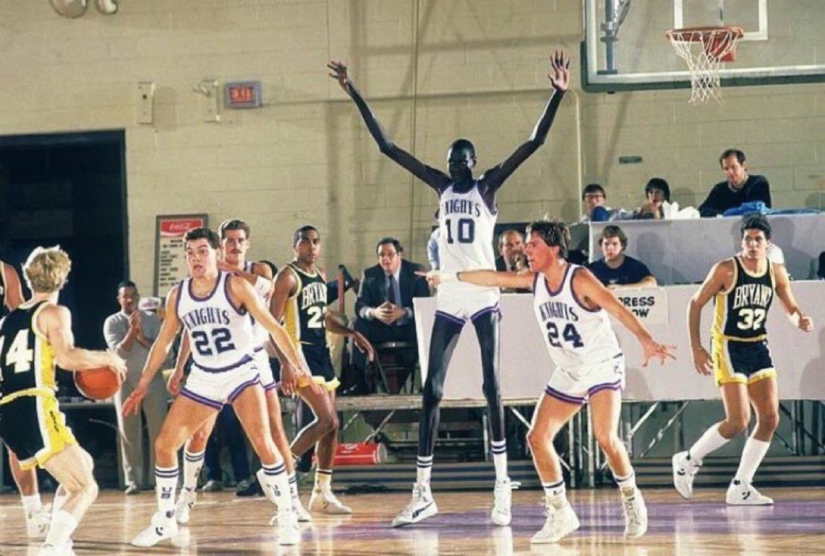 Super70sSports's tweet image. Imagine you’re on some NCAA Division II team and your bus rolls into fucking Bridgeport, Connecticut, on a cold January night and then out comes Manute Bol to swat your weak Division II shit all over the arena all night long. That had to be fun.