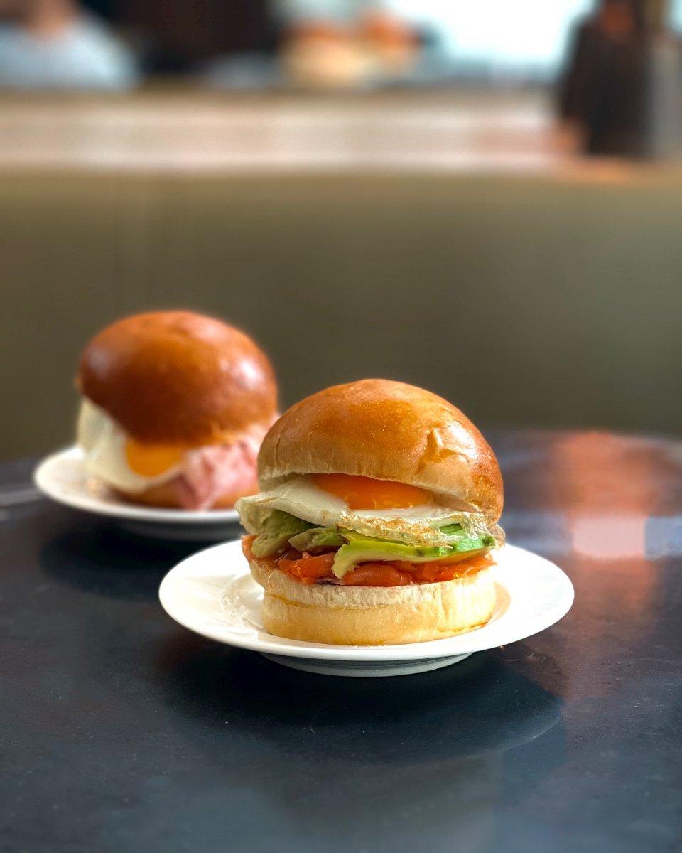 Our breakfast egg buns are the best way to start the day. Made with home made brioche, fried egg and your choice of salmon and avocado, or ham and cheese.