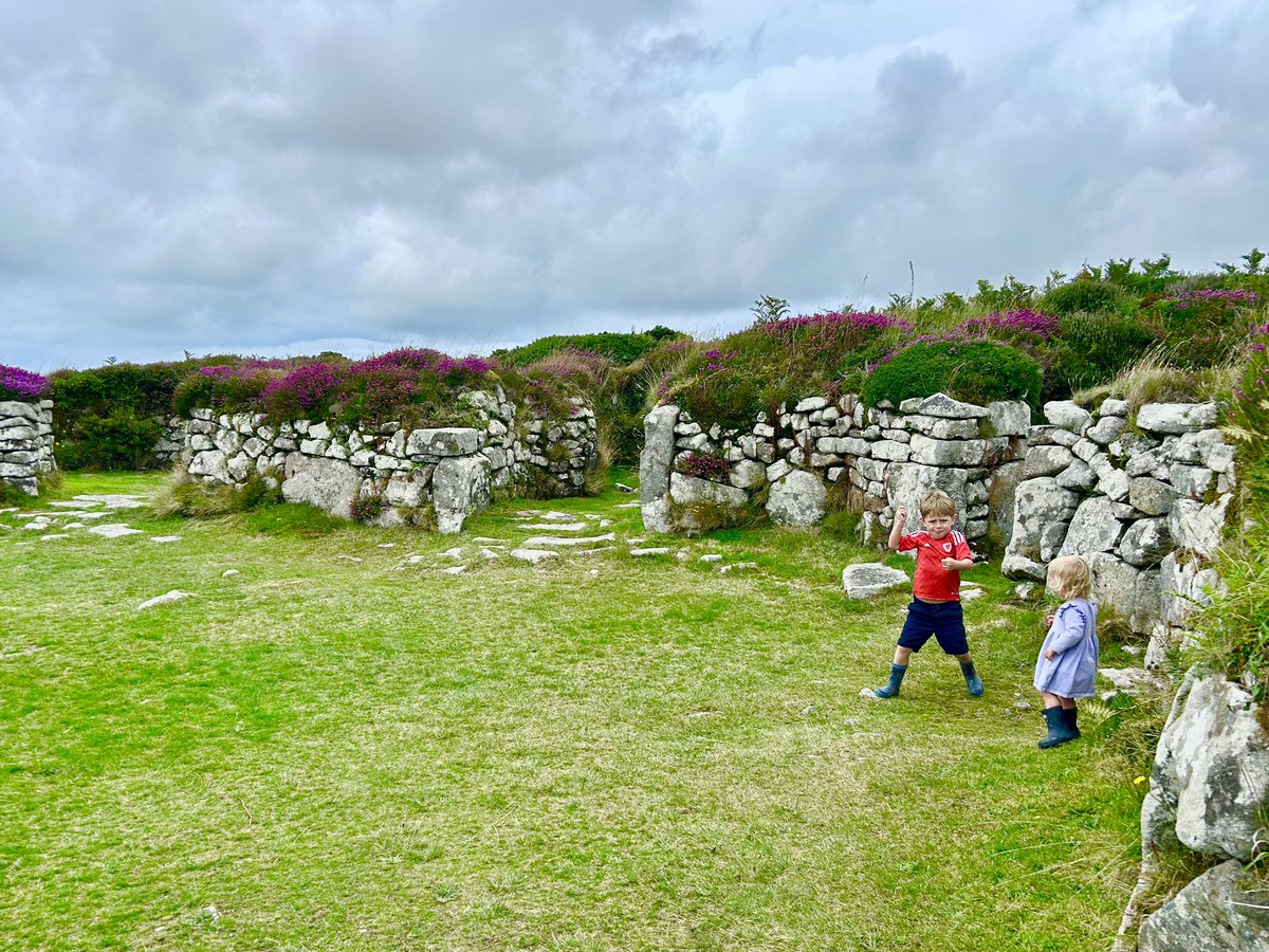 RozierHistorian's tweet photo. Two children in a 2000 year-old ruined village @EnglishHeritage #Chysauster 
(And yes he has a Wales football shirt: he was born there!) https://t.co/7jbzSuOxoj