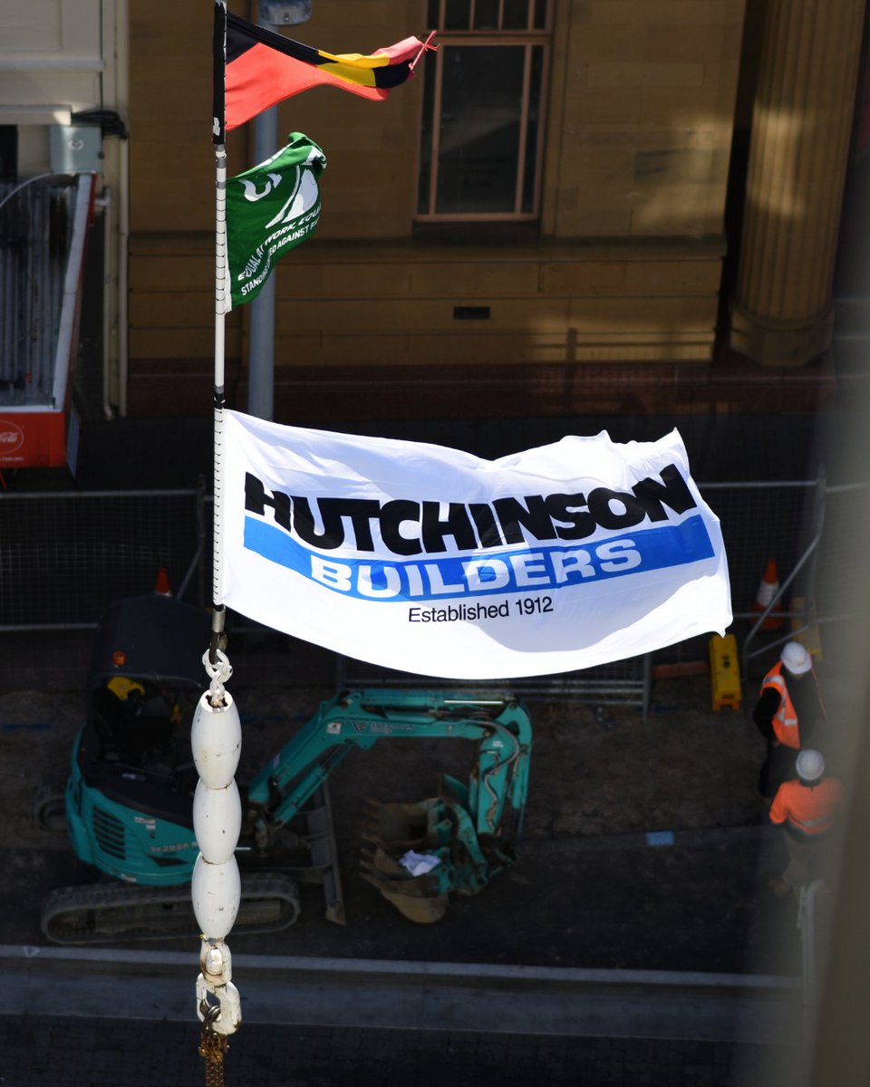 Reaching new heights with our custom branded flags! 🏗️ Fantastic to see our flags flying atop this <a href="/hutchinsonbuild/">Hutchinson Builders</a> crane