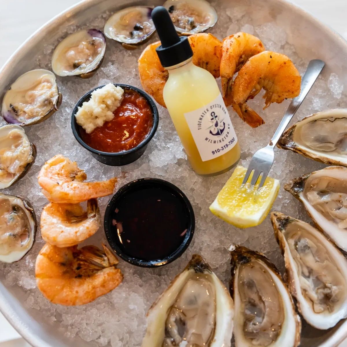 From the moment you step through our doors, you'll feel the warm coastal atmosphere that sets us apart. Whether you're enjoying a plate of freshly shucked oysters or savoring a mouthwatering seafood platter, every bite transports you to the ocean's embrace.