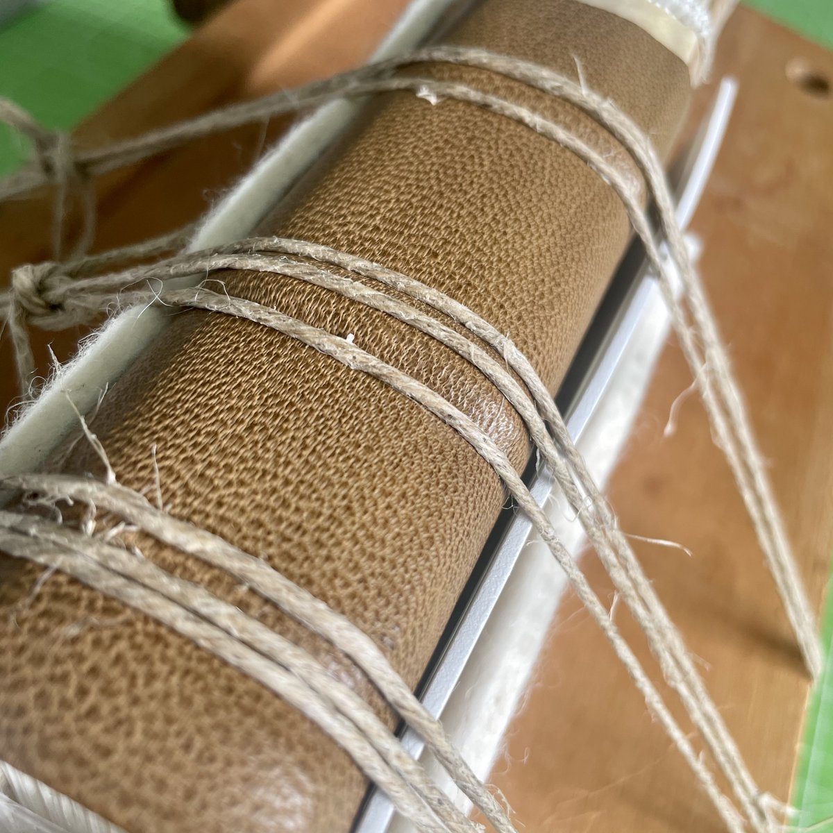 Work in progress… I don’t have a proper tying up press, so some creative knot work was required for this medieval style cutaway binding. Itching to undo it all and see how it looks.
.
.
.
#bookbinder #iona #handbookbinding #makingbooks #medievalbook #isleofiona
