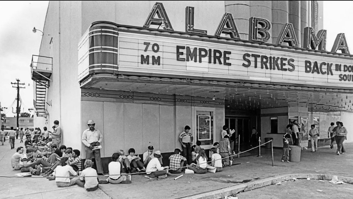 TracesofTexas's tweet photo. Folks wait outside the Alabama theater in Houston for the premier of The Empire Strikes Back, the second movie in the Star Wars saga, 1980.  The Alabama Theatre is a historic movie theater located at the intersection of Alabama Street and Shepherd Drive in the Upper Kirby district of Houston, Texas. Constructed in 1939 in the Art Deco and Streamline Moderne styles as a suburban theater, the Alabama primarily booked roadshow engagements through most of its history. It was a Bookstop for quite a while. Today, the theater is home to a Trader Joe's grocery store. It has a fabulous huge medallion on the ceiling. It took restoration crews more than 1000 hours to restore that medallion when Trader Joe's moved in.

Photo courtesy the awesome folks at @HoustonChron.
