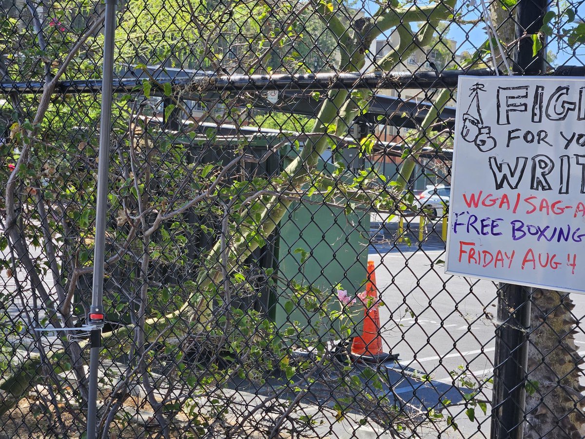 flying_lobster's tweet photo. Day 94. An open dumpster just showed up on the other side of the fence by our picket sign-in at Television City. Not pictured: the smell & flies. Whatever reason they put it here in particular, we are not going anywhere, until we have a fair contract. #WGAStrong #CloseTheLid https://t.co/oHknnMVrvU