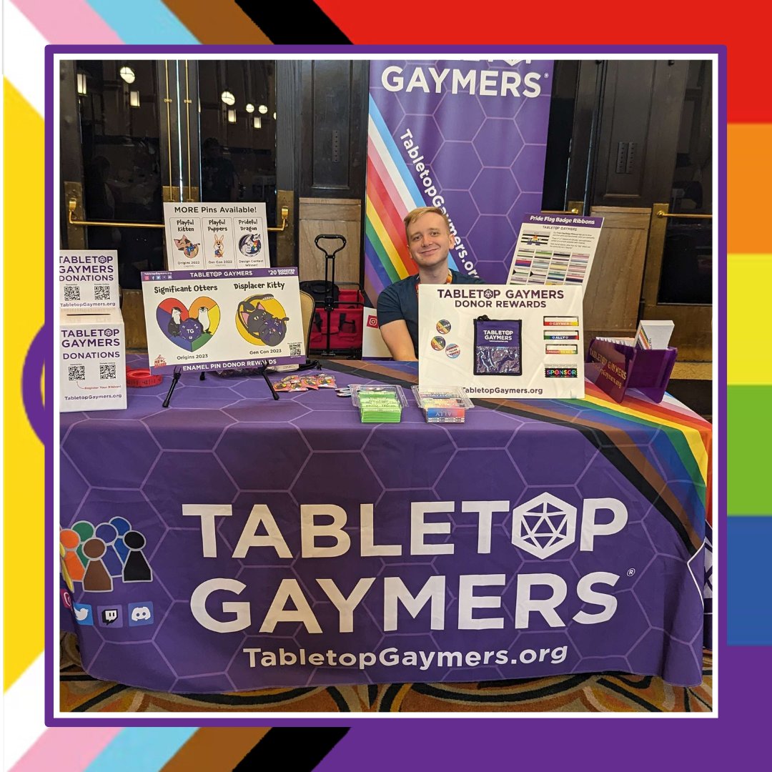 TabletopGaymers's tweet photo. We have a table on #CommunityRow again with lots of new swag to choose from, including some awesome new pins. Stop by, say hello, and pick up some swag! #tabletopgaymers #gaymers #gencon #gencon2023 https://t.co/iG92TuYQn4