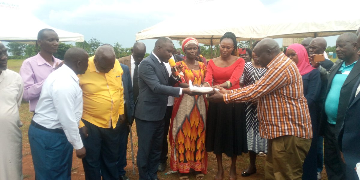 Bugiri District Chairman,Mr. Mulumba Kasajja hands over Primary seven mock exams to the CAO-Mr Mabanda Kisule.The exams were printed by the Mulumba Kasajja Davidson Education support Foundation to give chance to 6,500 Primary seven pupils in the district to be assessed at no cost