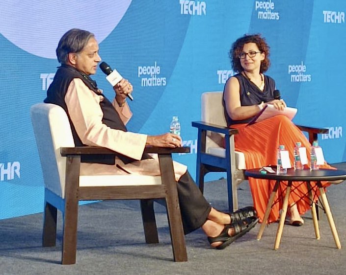 ShashiTharoor's tweet photo. Thoroughly enjoyed a stimulating conversation with Ester Martinez of @PeopleMatters2 at their annual #TechHR conference in Gurgaon. It took place in an overflowing hall, with dozens of people standing in the aisles & the event ran 15 minutes longer than scheduled for, because of the number of questions from the audience. One audience member called me a “human ChatGPT” and I didn’t know whether to be pleased or offended! Will post video when available. (Ended with a group pic with the conference organisers: it IS a woman’s world!)