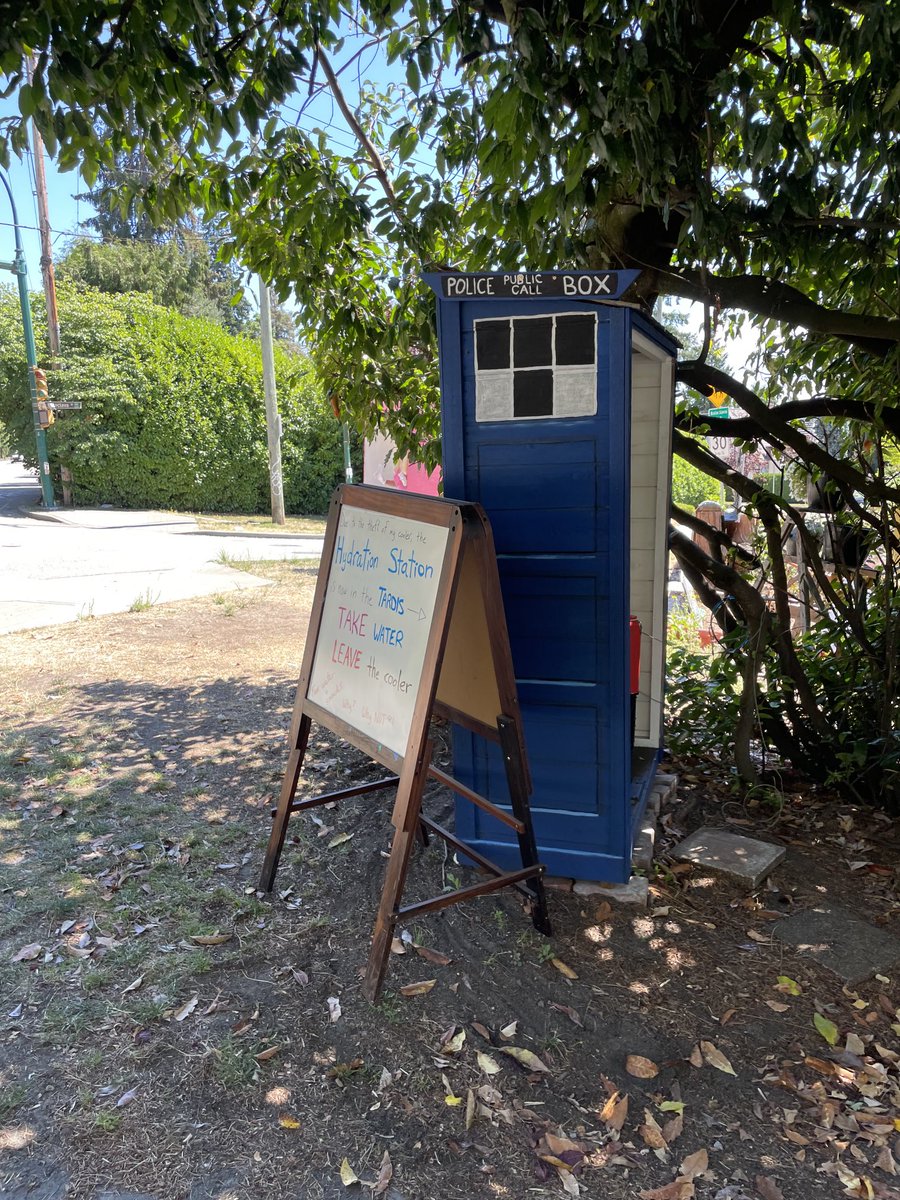 Just a woman in West Van, spreading joy and cold water to passers by. Why? Like the sign says, why not? She made my day.