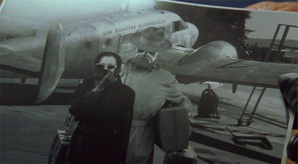 awoodustin's tweet image. At one point Commissioner Gordon hands Batman this photo of two mysterious figures getting on a plane and says he suspects it might be Bane and Poison Ivy