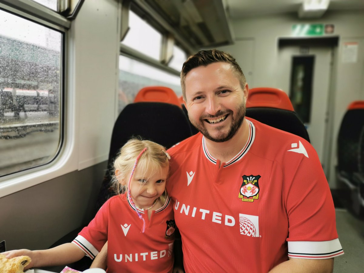 CochionDubaiUAE's tweet photo. Dubai Reds member Poppy (5 years old) on her way from Cardiff to @Wrexham_AFC with her dad & 2 uncles for her first ever live football game. She can't wait to sing @RMcElhenney, @fearlessidzine & @WXM_Lager in person at the match 😂
#dubaireds #porttalbotreds #FirstEverGame https://t.co/DtTSy6X4RU