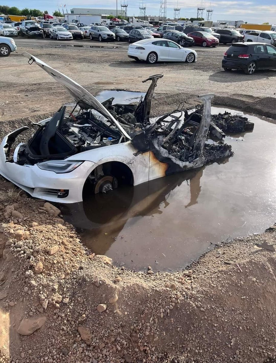 exRAF_Al's tweet photo. It took firefighters 4 hours and 16,000 litres of water to prevent the batteries on this Tesla from reigniting. Eventually they had to dig a hole, fill it with water and drag the electric vehicle into the pool of water to extinguish the blaze once and for all. https://t.co/vda5AGzwgs