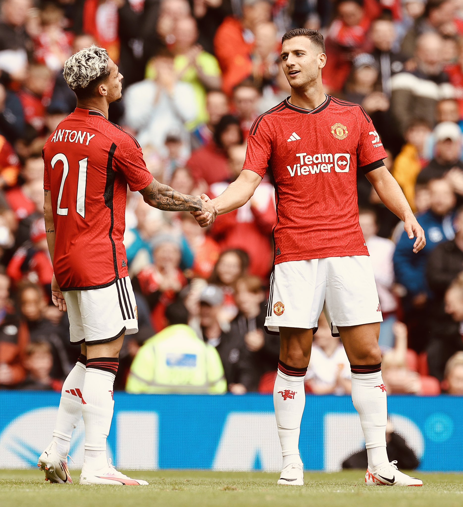 Antony celebrates his goal v RC Lens with Diogo Dalot.