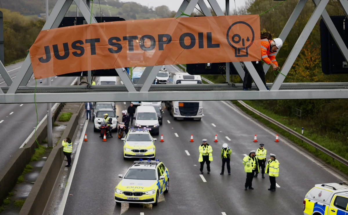 Monday, 7 November 2022. 23 Just Stop Oil supporters close parts of the #M25 in 13 locations by climbing onto the overhead gantries. The blockade continues for four days. By day four, 20 are in prison without trial. Average global temperature: 13.99°C.