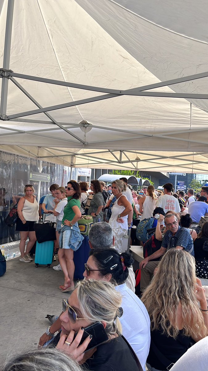 NDGTherapy's tweet photo. @CTAairport This is the chaos at so-called Terminal C at Catania Fontarossa Airport.  No access to Wifi, toilets (unless you consider Johnny-on-the-spot adequate for these hordes, God speed), and no information (just the same nonsensical message over and over again to “follow the line.” https://t.co/GuQ1ozYeVg