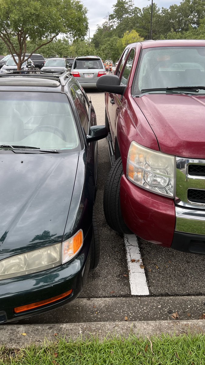 This morning at Home Depot. Big trucks + bad drivers = lines in the parking lots need to be farther apart. I am glad I came out first so I could get in from my passenger side and skillfully back out of there because they for sure would have hit my car backing out.