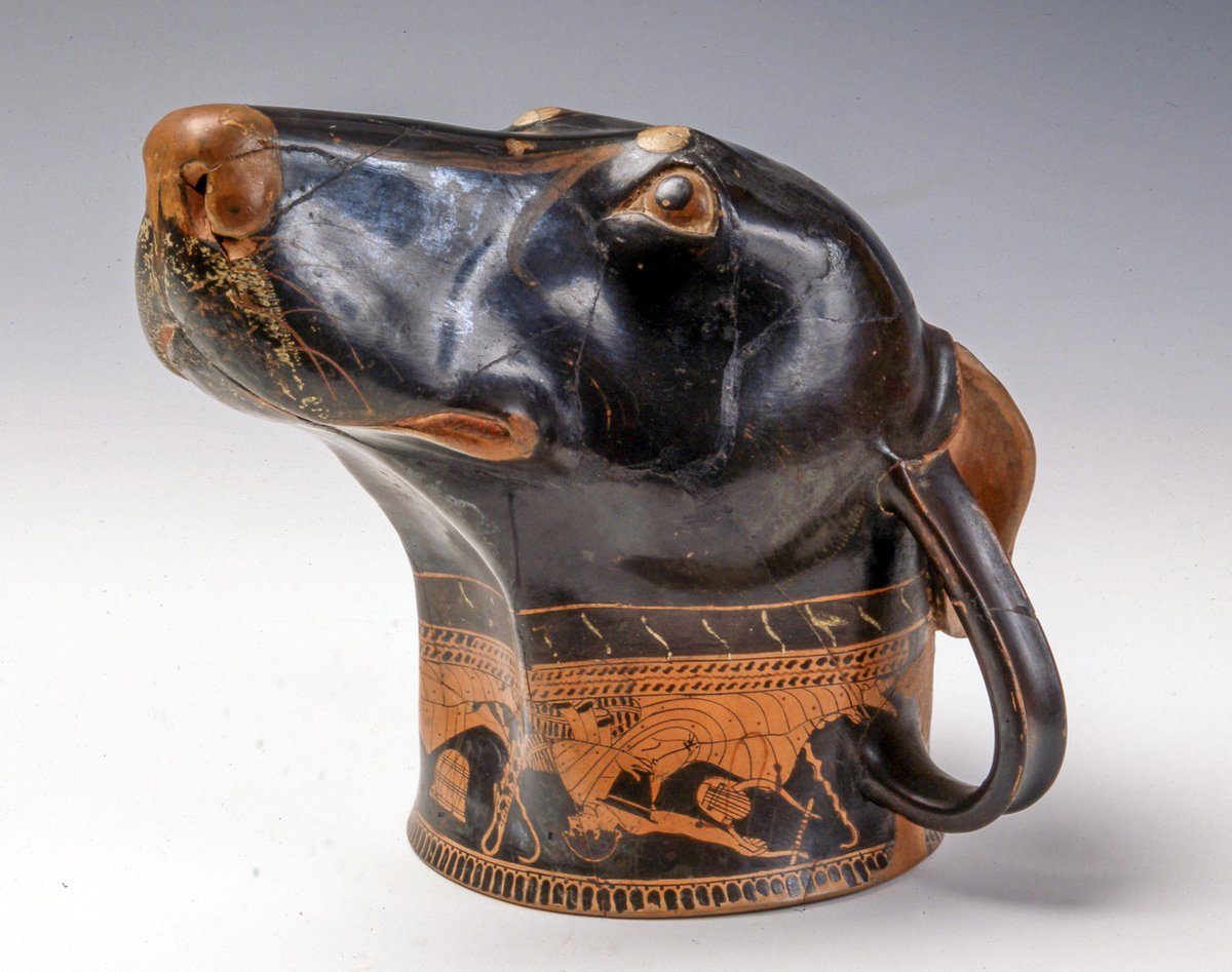 Rhyton drinking cup in the shape of a dog's head. The beautiful vessel is attributed to the prolific ancient Greek potter, Brygos, who was active in Athens between 490-470 BC and whose fine work is known from around 200 surviving pieces. 
Intentionally made without a flat base,
