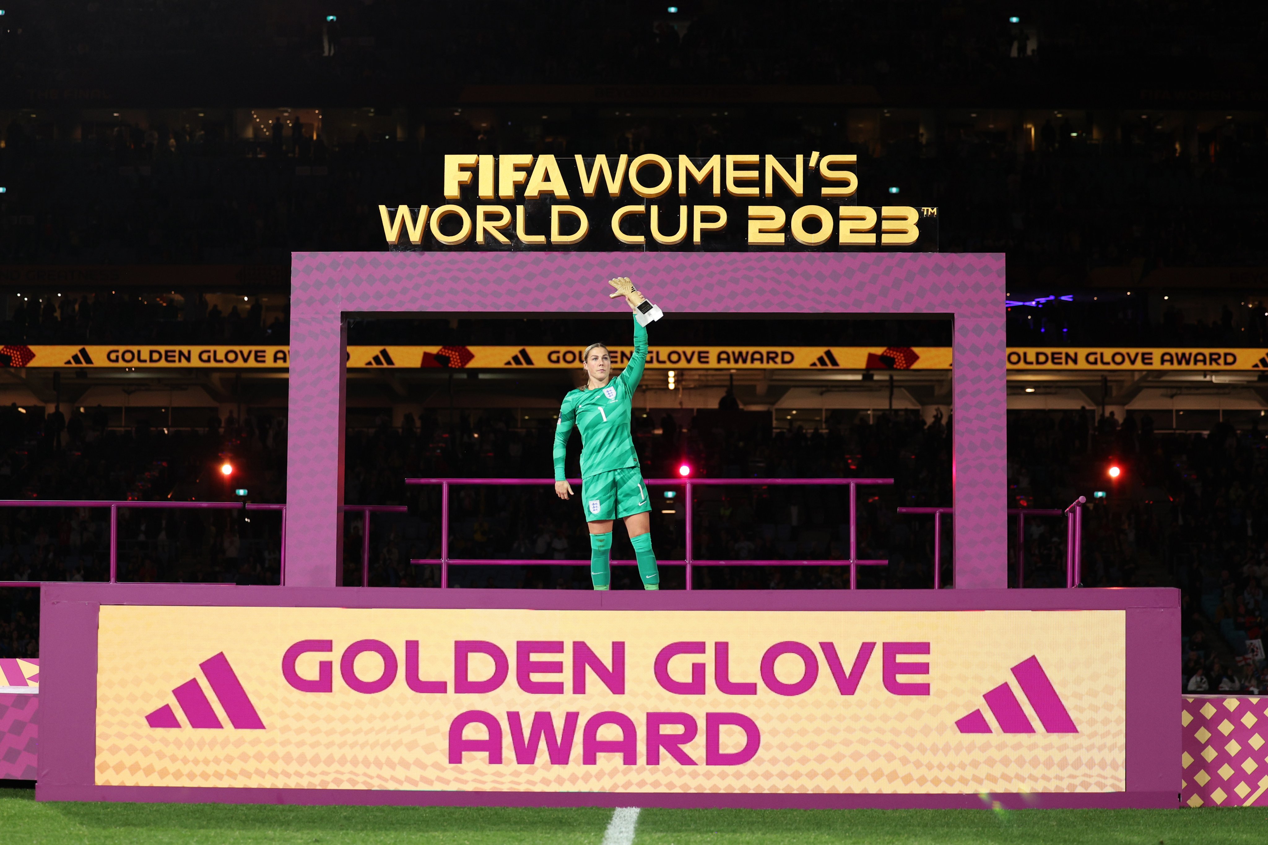 Mary Earps lifts the Golden Glove trophy aloft.