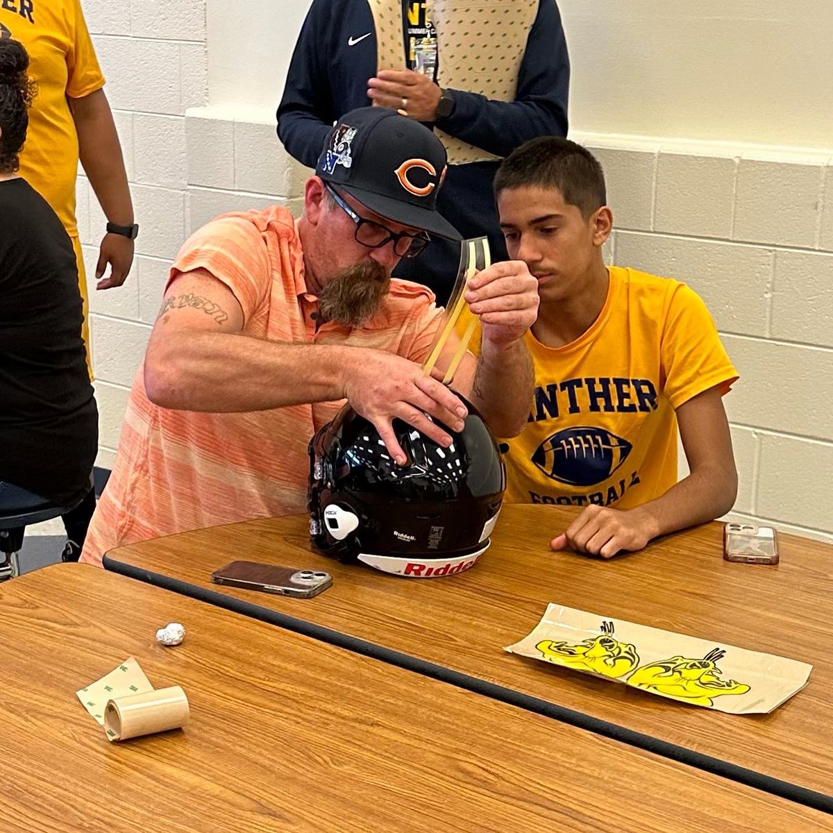 RLHSFB's tweet photo. Yesterday our Varsity team members invited guests to help put decals on our helmets and join us for lunch. Thank you to everyone who was able to join us. Round Lake High School Athletics #KeepBuilding #ProtectTheTeam #Believe #WeAreRL #PantherPRIDE #decalday https://t.co/ZWRVTuJdlS