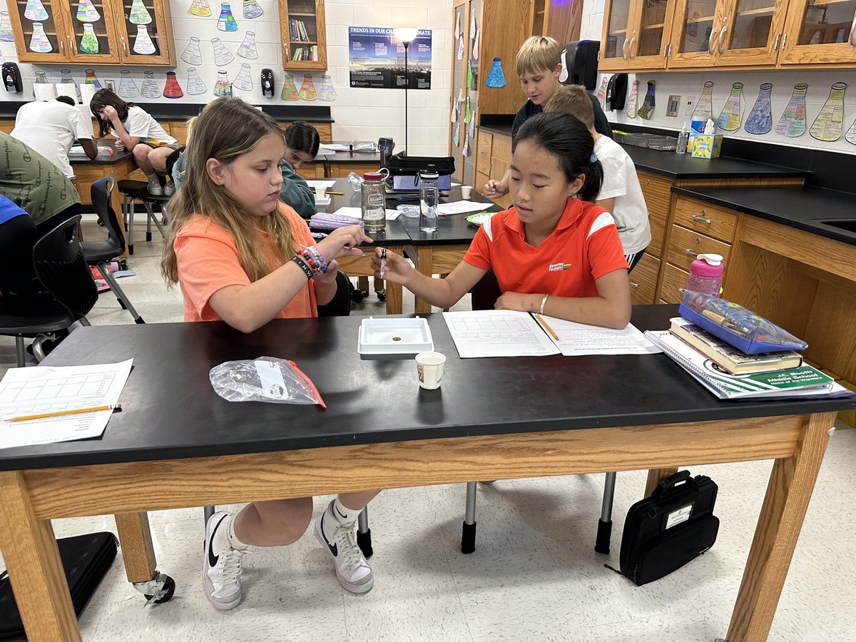 Going through the Scientific Method. Students completed research on the Penny and water to make a sound hypothesis on how many drops of water will fit on a Penny. Then, students completed 5 trials, recorded and graphed results before coming up with a conclusion. <a href="/jcboothmiddle/">J. C. Booth Middle</a>