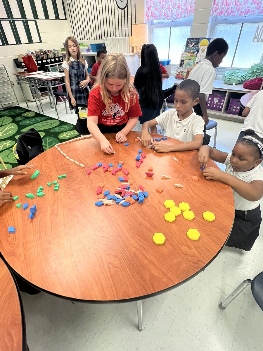 Golden2nd's tweet image. Students are learning all about triangles, quadrilaterals, pentagons, and hexagons. After sorting shapes and naming the number of vertices students created pictures as a collaborative team.  @MaryBAustin ##AimForExcellence #LearningLeading