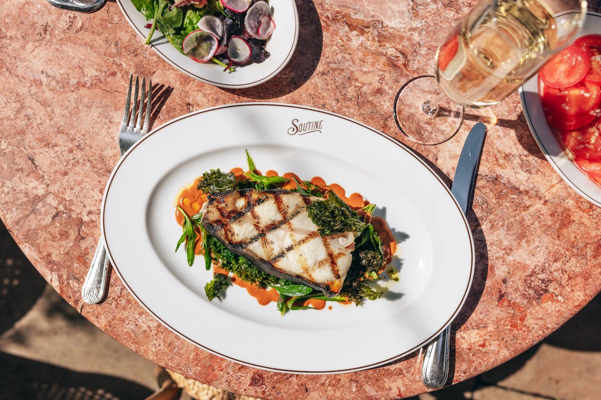 Roast Tranche of Halibut served with sea vegetables and a langoustine bisque sauce, al fresco