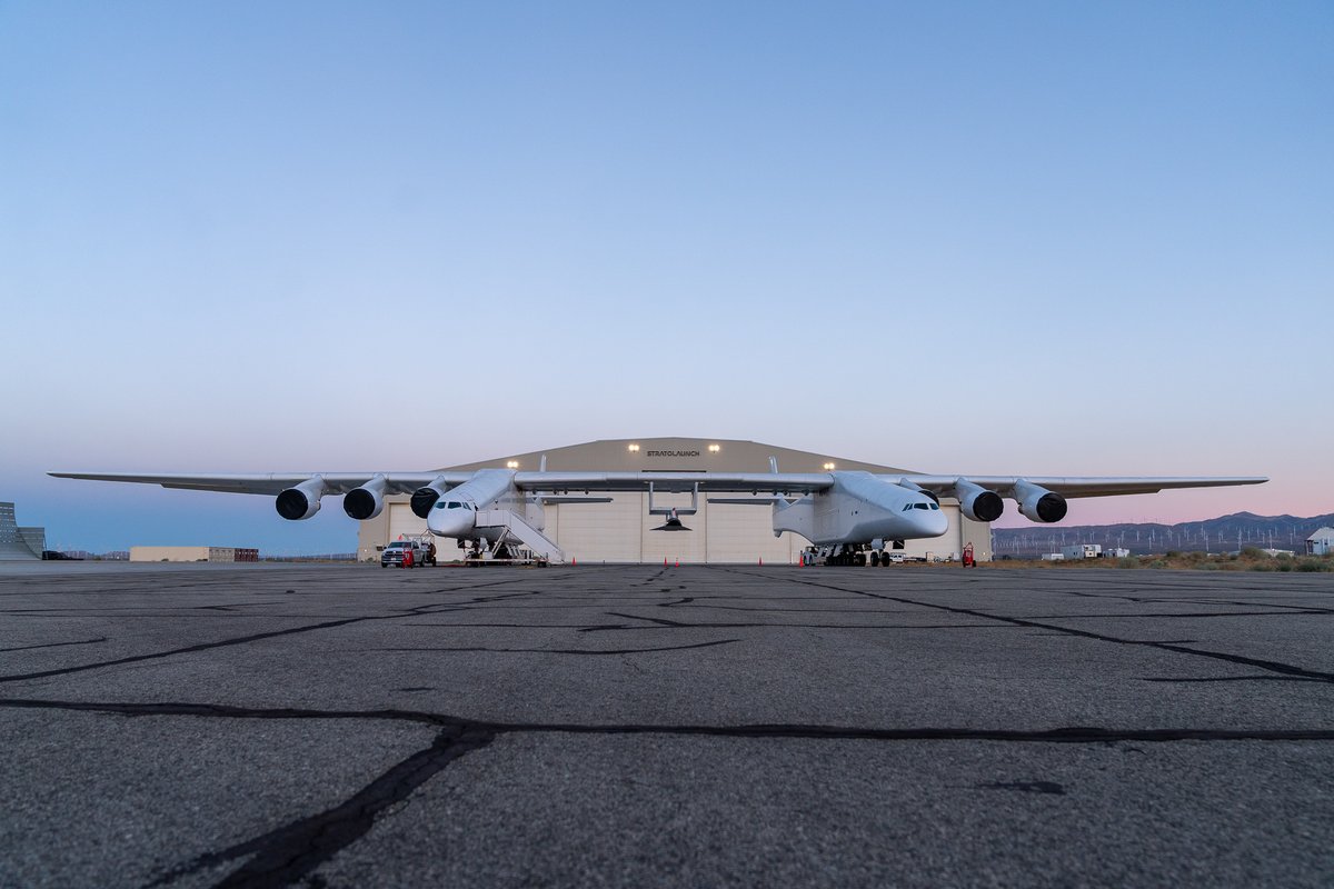 Stratolaunch's tweet photo. For the 1st time as an integrated system, Roc and TA-1 headed outside today ahead of #HurricaneHilary to do some ground tests, including fueling part of TA-1’s propulsion system. TA-1 will be our first powered #hypersonic vehicle, anticipated to fly in the coming months. #LetsRoc https://t.co/m2ttXF5gIS