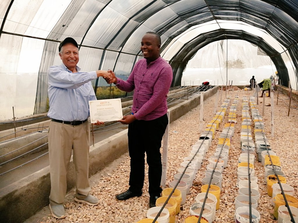 Evariste  Nsabimana from <a href="/spf_ikigega/">SPF-Ikigega</a> receiving his special recognition certificate from Dr. Victor Otazu