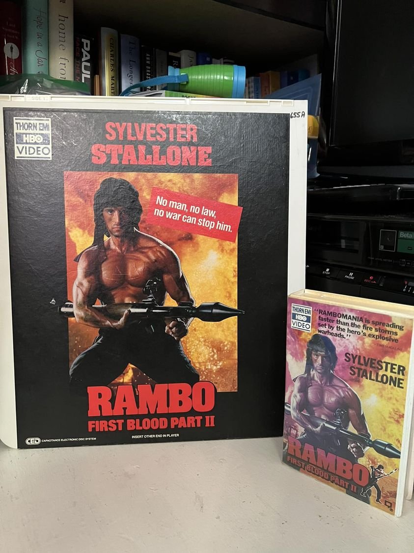 RockVideoRental's tweet photo. This friday...
Action August EXPLODES again with
Rambo: First Blood Part II

now I have to decide...CED or Betamax?
#DeadFormat #CED #VideoDisc #Selectavision #Beta #Betamax #PhysicalMedia #Vintage https://t.co/xnpAzbk35n