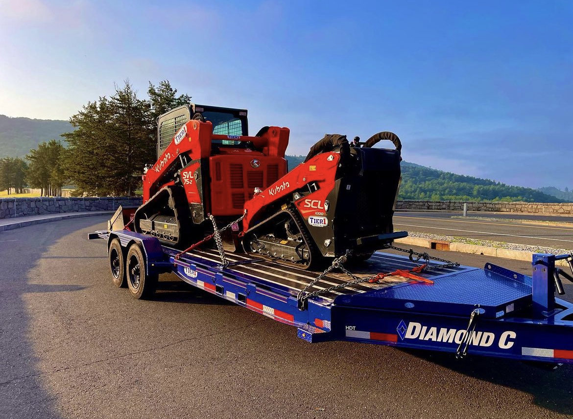 Unleashing the power of the HDT: Low Profile Hydraulically Dampened Tilt Trailer this #TrailerTuesday 🔥 With its cutting-edge design and hydraulic dampening system, it's a smooth and secure ride for 2 Kubotas. 😎 #DCtrailers #EquipmentTrailer #TiltTrailer #DiamondC