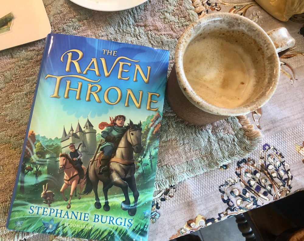 Celebrating The Raven Throne's book birthday with a very large coffee! I'm so happy to have this book (full of big world magic, companionable hedgehogs, feisty red squirrels, & a loving, squabbling family desperate to protect one another) out in the world at last.