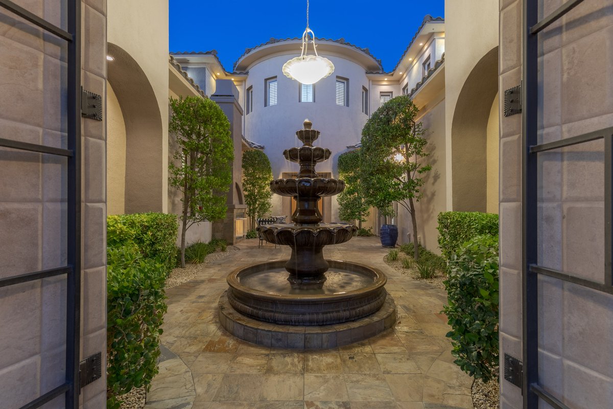 Enter through the spacious courtyard, where the mood is set by a water feature and outdoor fireplace... #10AnthemPointe • Anthem Country Club • $3,500,000 6,784 SF • 4 Beds • 5 Baths • Pool & Spa ML#2513687