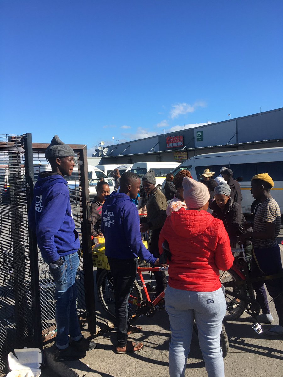 LangaBicycleHub's tweet photo. Amid a taxi strike, mechanic Nqununu & Learn2Cycle's Siphelele stepped up. They sold plastic bags at Langa @BoxerSuperstores due to shortages during our bike deliveries. #CommunityIngenuity ๐ฒ๐๏ธ https://t.co/Nw9LoH28OI