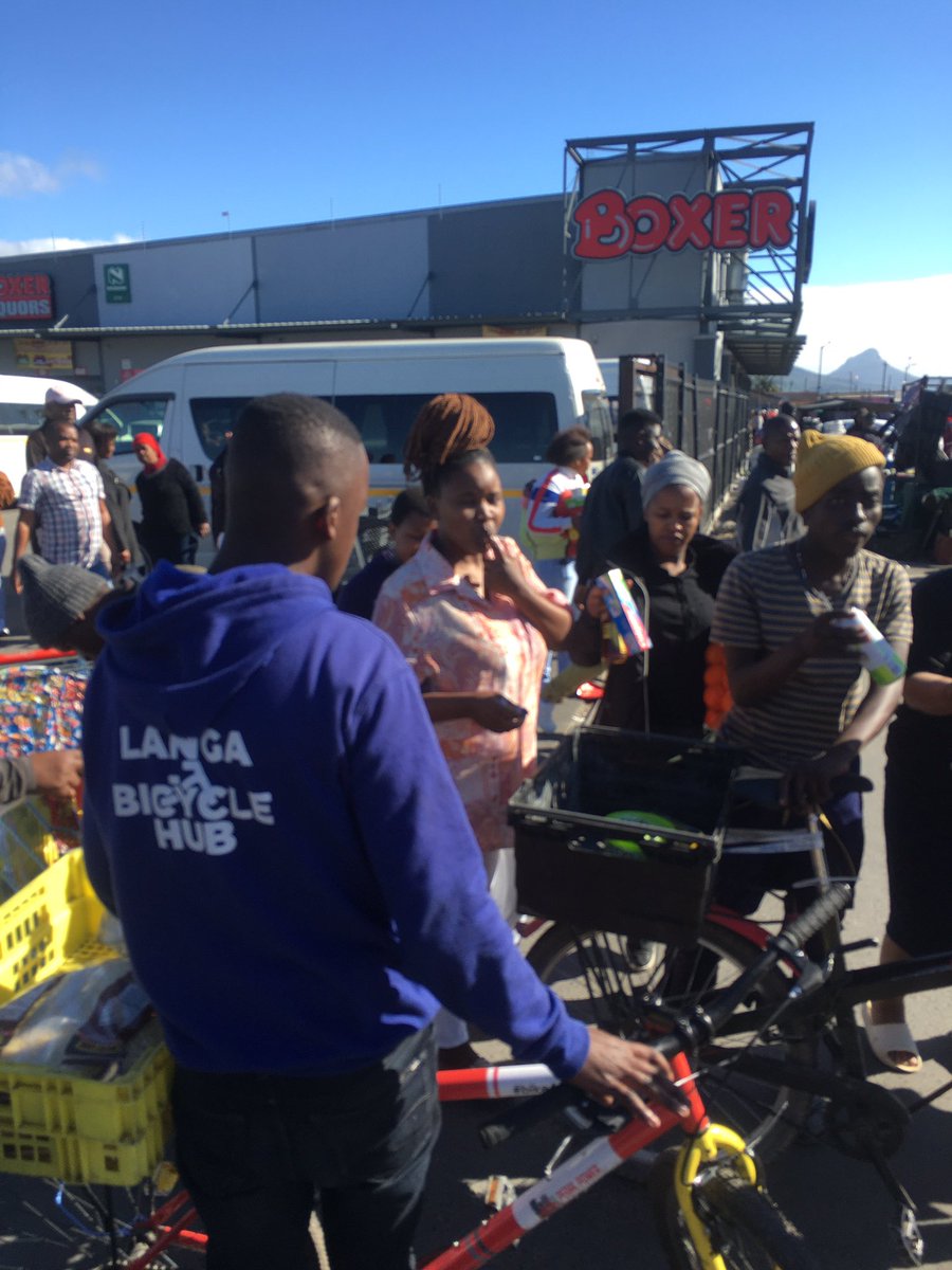 LangaBicycleHub's tweet photo. Amid a taxi strike, mechanic Nqununu & Learn2Cycle's Siphelele stepped up. They sold plastic bags at Langa @BoxerSuperstores due to shortages during our bike deliveries. #CommunityIngenuity ๐ฒ๐๏ธ https://t.co/Nw9LoH28OI