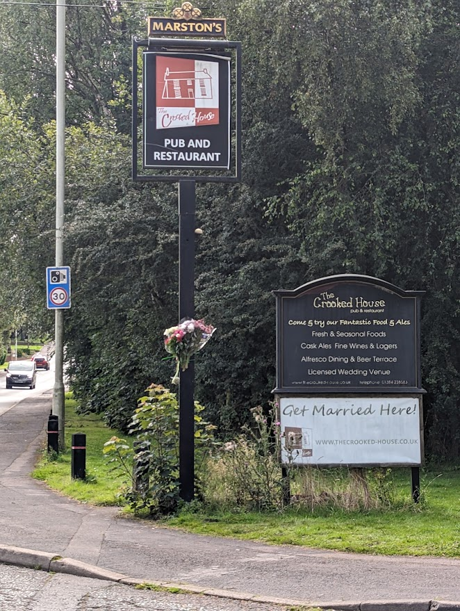 Local people feel genuine loss at the fate of the #CrookedHouse 
Driving past  I sew someone has left a bunch of flowers on the welcome sign - all that is left of this piece of history. My 1st date with my wife was at the Crooked House in 1982. Whats your #CrookedHouse story ?