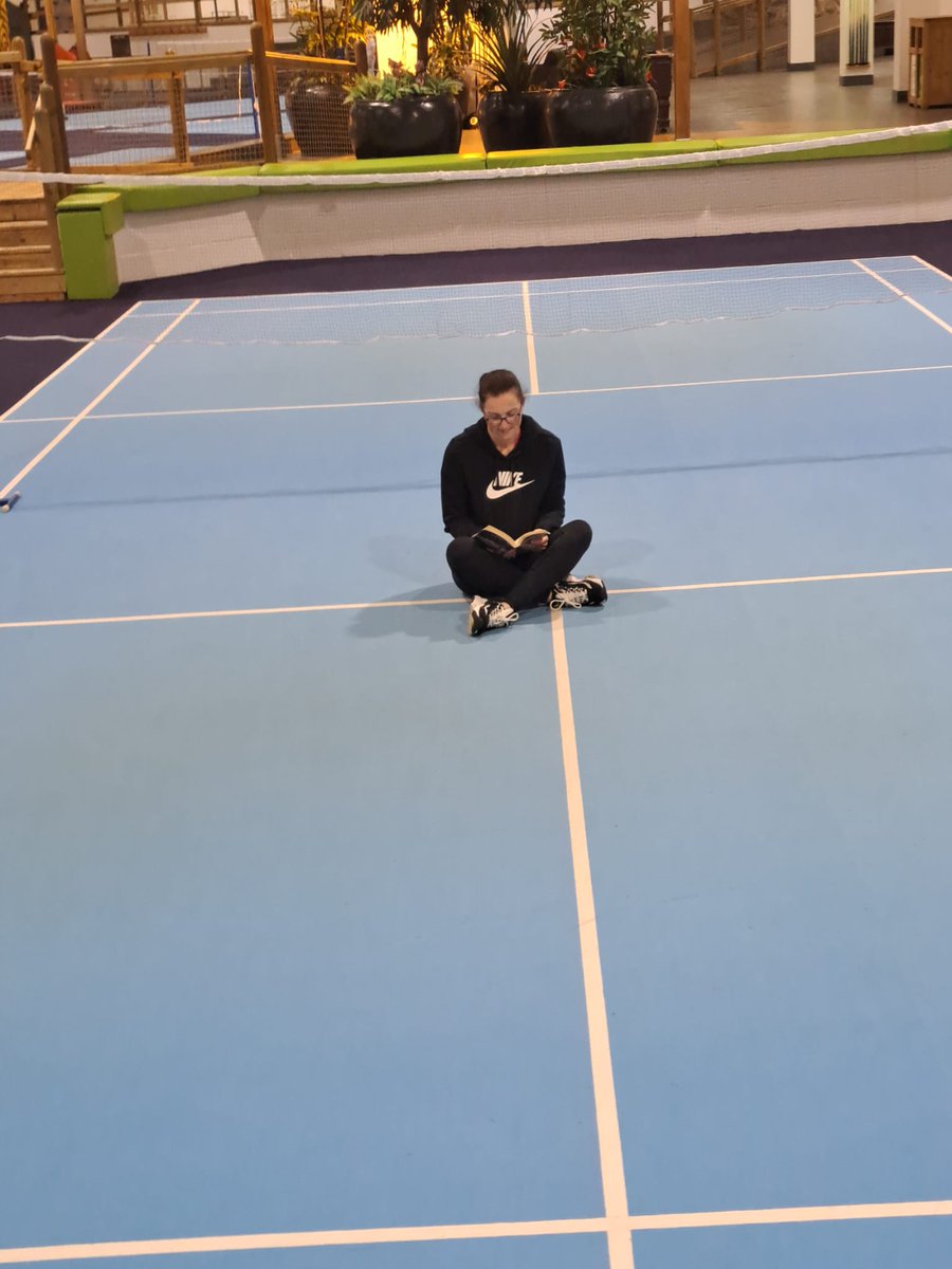 jemburton's tweet photo. @SandwichJunior Mrs Burton reading somewhere sporty, she even managed to find a quiet spot in the middle of a Badminton court! 🏸📖
#summerreadingchallenge https://t.co/GlMFOJbSI1
