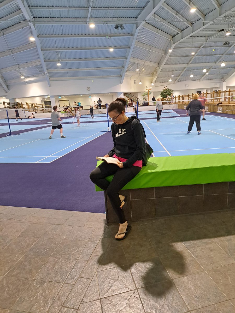 jemburton's tweet photo. @SandwichJunior Mrs Burton reading somewhere sporty, she even managed to find a quiet spot in the middle of a Badminton court! 🏸📖
#summerreadingchallenge https://t.co/GlMFOJbSI1