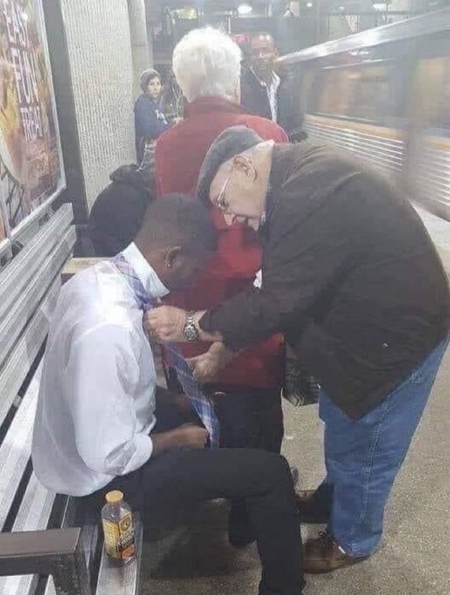 Brink_Thinker's tweet image. This young man was on his way to a job interview and had some difficulty tying his tie. The lady in the red coat noticed him struggling and nudged her husband to help. 

This act of kindness deserves to be shared 🤗