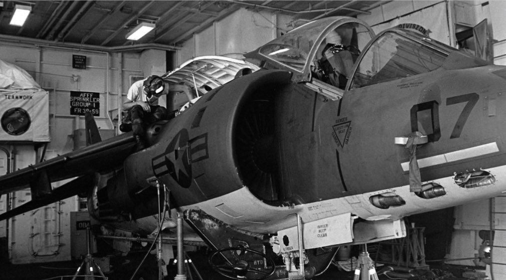 HarrierPres's tweet photo. This AV-8C is undergoing engine checks and repairs in the small hangar of a LPH class. Note the jacks being used to secure the aircraft. #AV8C #AV8A #HarrierUSMC #Harrierpres https://t.co/Nt4g4TlPC0