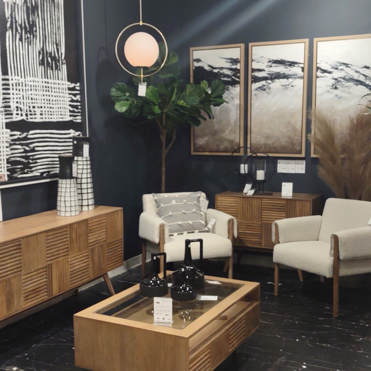 Mercana's booth at the Las Vegas Market! We loved the use of a dark accent wall to make the warm wood furniture stand out 🙂