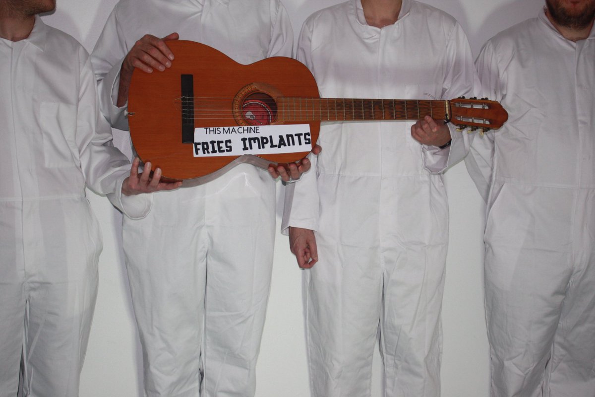 Meet: This Machine Fries Implants. They are the band from my book so they are from the future and they are make-believe but their CD will be hidden in your copy of my book. (No they aren’t wearing white overalls, silly. You’ll see their clothes when you get your implant fitted.)