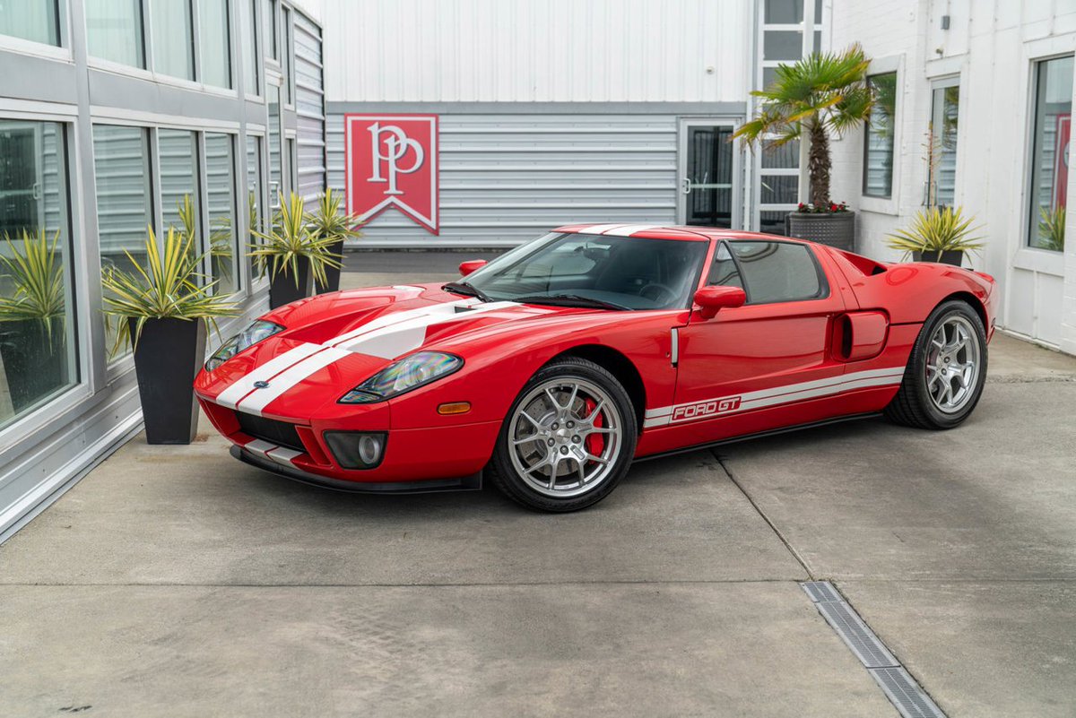 RevolutionRides's tweet photo. There's a lot of talk about #Ford going on right now, so let's take it back to the good ole days with this 2005 Ford GT Coupe.

Vehicle: 2005 Ford GT Coupe
Miles: 3,622
Transmission: 6-speed Manual
Price: $424,950
Seller: Dealer
Horsepower: 550
0-60: 3.4 seconds

Background: Experience the thrill of driving a true automotive legend with this remarkable 2005 Ford GT in sensational Mark IV Red with White Stripes. This exquisite example boasts ultra-desirable equipment, encompassing all four factory options, making it a blue-chip collectible that stands out from the crowd.

Equipped with the rare Painted Racing Stripes ($5,350), which adorn the hood, roof, and rear hatch, this Ford GT exudes a timeless racing aesthetic that pays homage to its storied heritage. Immerse yourself in unparalleled auditory bliss with the McIntosh Audiophile Stereo ($4,000), delivering 300 watts of pristine sound through a single CD player, a 200-watt 3-channel amplifier, an 8" subwoofer, and soft dome door tweeters, all beautifully presented on an illuminated faceplate featuring the iconic McIntosh and Ford GT logos.

Enhancing both performance and aesthetics, the Forged BBS Lightweight Aluminum Wheels ($3,500) in an 18"/19" staggered setup perfectly complement the car's dynamic profile. The red-painted brake calipers ($750) provide a striking contrast and highlight the exceptional engineering beneath.

This Ford GT represents a rare find, being one of only 2,027 cars produced in 2005, and it comes complete with a car cover, books, and manuals. Under the hood, you'll discover the heart of a beast—a 5.4-liter supercharged V8 engine generating a jaw-dropping 550 horsepower and 500 lb-ft of torque. The power is harnessed through a precise 6-speed manual transaxle, supported by a track-tuned suspension and 4-wheel disc brakes for an exhilarating driving experience.

Despite its performance prowess, this Ford GT doesn't compromise on comfort, featuring power windows, mirrors, and a reliable air conditioner to ensure an enjoyable ride in any condition. The full instrumentation keeps you informed, and the iconic design leaves an indelible impression wherever you go.

Don't miss the opportunity to own a piece of automotive history—a true masterpiece that embodies power, style, and exclusivity. This 2005 Ford GT is more than a car; it's a statement of automotive excellence.