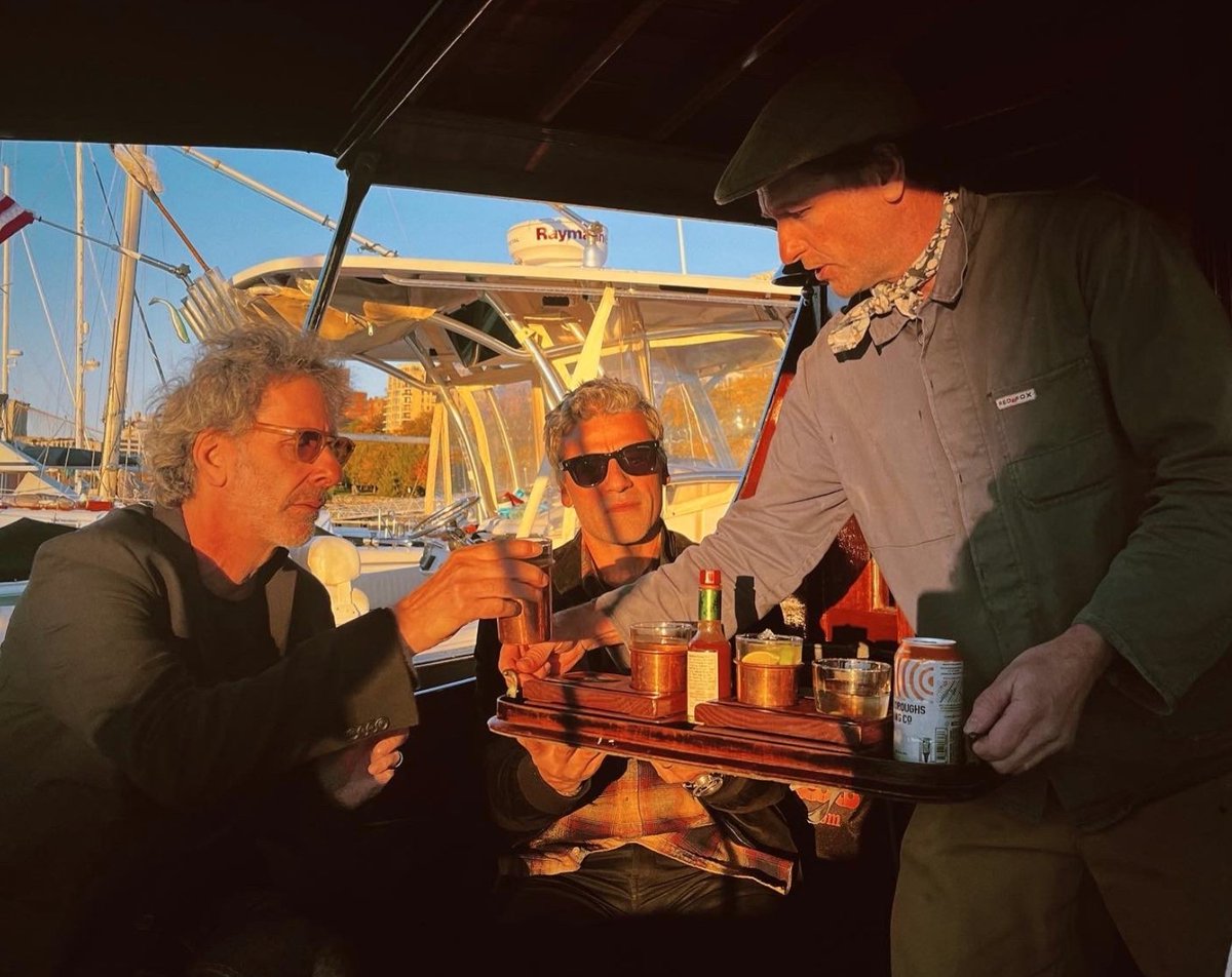 nataliawinke's tweet photo. for your consideration: matthew rhys wearing a neckerchief while serving cocktails to oscar issac and joel coen on the small wooden boat he restored https://t.co/LMlSpRDU8l