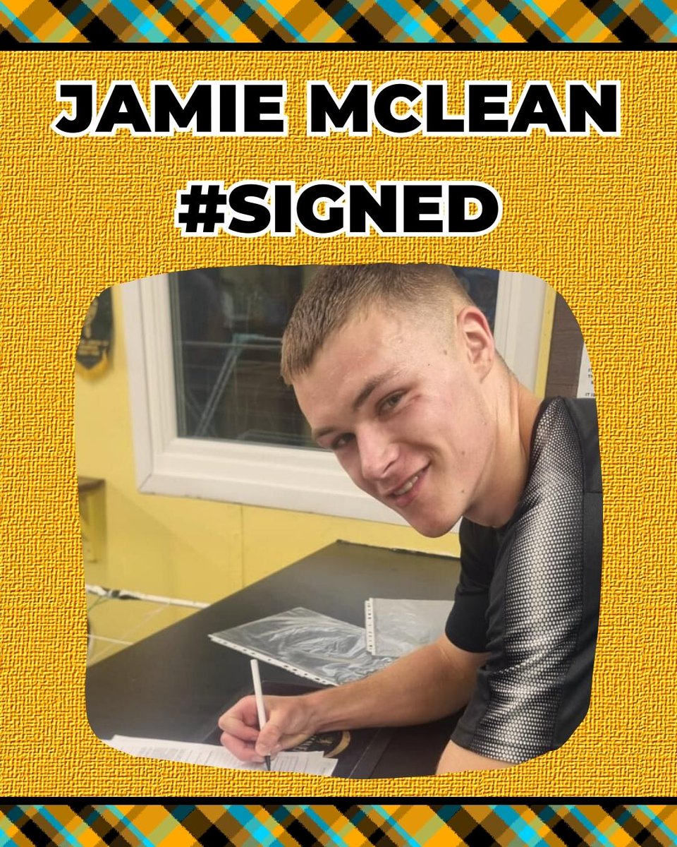 Jamie McLean, signing a contract in the office at Barrfields Stadium. He is wearing a grey shirt.