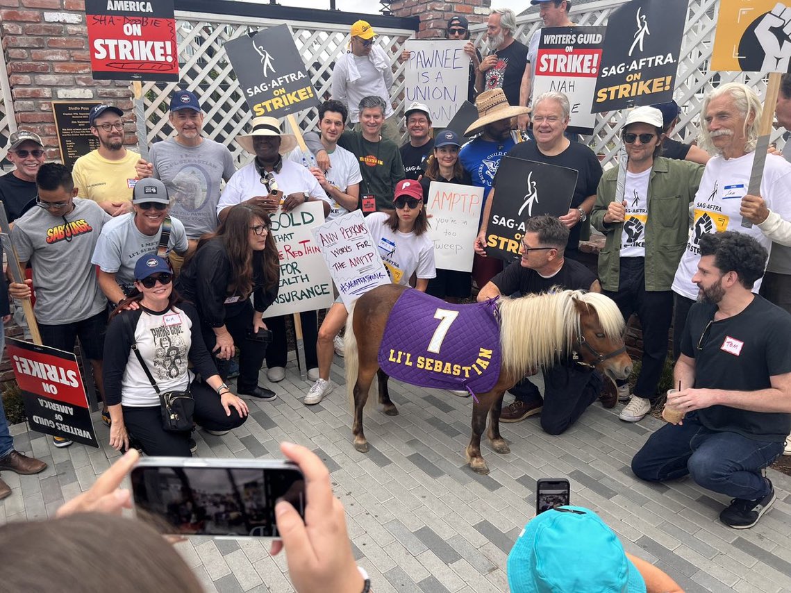 sapphicrogue's tweet photo. they got lil sebastian on the picket lines https://t.co/ornYQgVpMS