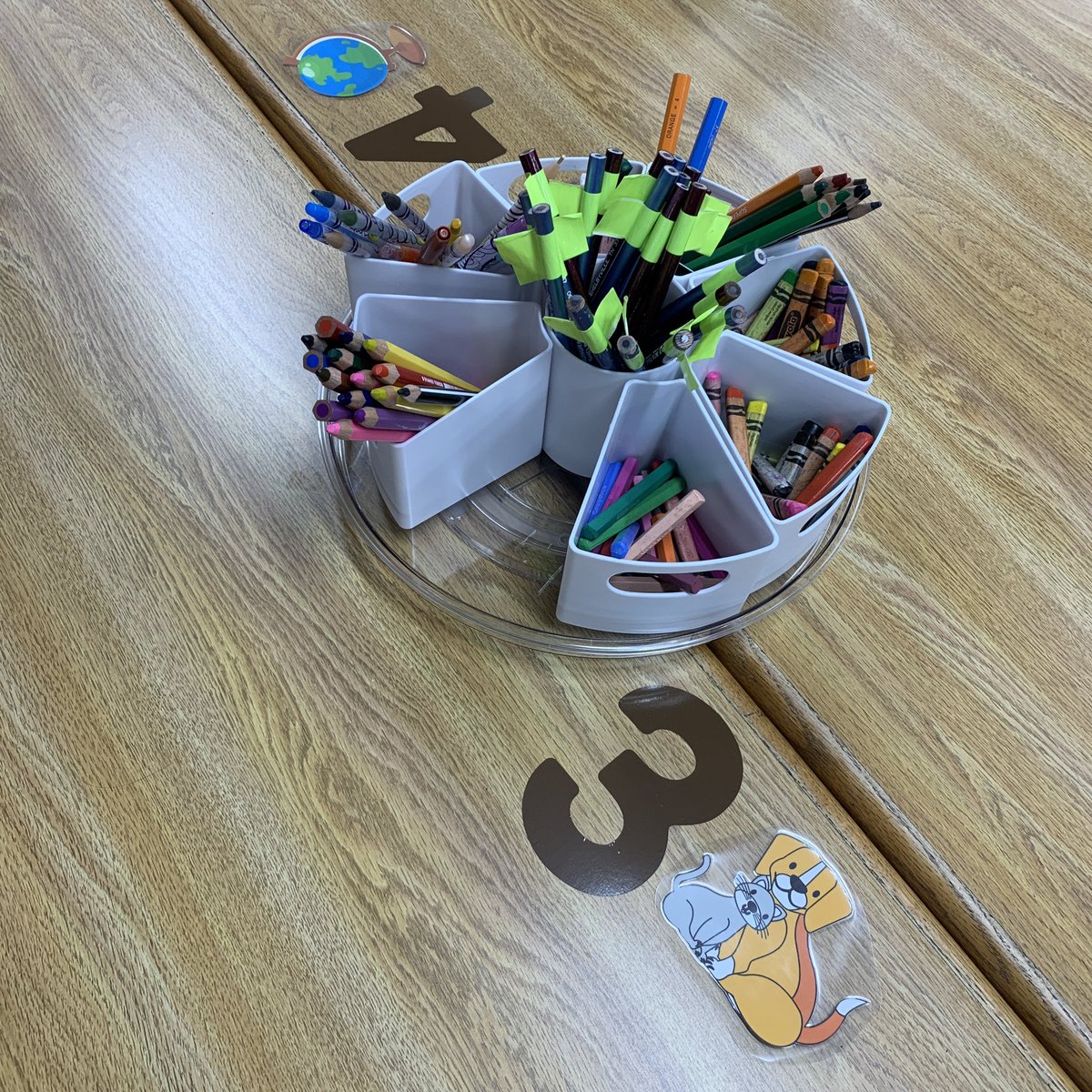 carolynvibbert's tweet image. Another small space finished! Lazy susans with removable supplies so I can put out only what is needed. Labeled tables to facilitate organized seating. I used symbols from popular nonfiction topics. #PWCSLibraries