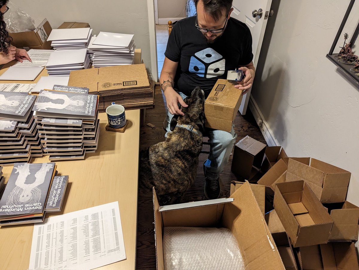 Packing of Seven Murders Til Midnight in progress with our official QA dog sniffing every box to ensure they are packed with care.